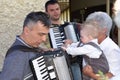 Sremska Mitrovica / Serbia - October 10, 2019: The child touches the accordion. Musicians play harmonious music and sing