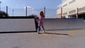 Sremska Mitrovica, Serbia, September 12, 2020. The girl is rollerblading on the asphalt. A 7-year-old child in a striped white and
