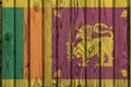 Sri Lanka flag depicted in bright paint colors on old wooden wall. Textured banner on rough background