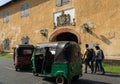 Sri Lanka: Galle fort old gate with coat of arm of East India company, tourist landmark wuth people and tuk