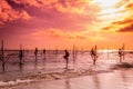 In Sri Lanka, a local fisherman is fishing in unique style in the evening