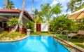 Swimming pool in tropical hotel or house. Panoramic scenic view of Idyllic courtyard Royalty Free Stock Photo