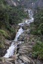 Sri Lanka. Ravana Waterfall. Beautiful view from below of the pouring water. Green trees grow around the waterfall.