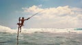 Sri lanka traditional `stick`- method fish catching Fisherman in the Indian Ocean waves. Royalty Free Stock Photo