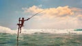 Sri lanka traditional `stick`- method fish catching Fisherman in the Indian Ocean waves. Royalty Free Stock Photo