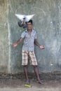 A Sri Lankan boy in Negombo releases his pigeon from its coop.