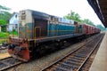 Sri Lankan Railways diesel electric locomotive train engine with passenger carriages parked at station