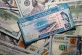50 Sri Lankan rupees on a background of 100 dollar bills