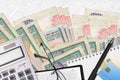 1000 Sri Lankan rupees bills and calculator with glasses and pen. Tax payment concept or investment solutions. Financial planning