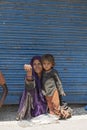 Poor Indian beggar woman ahd child on the street market in Srinagar, Jammu and Kashmir state, India Royalty Free Stock Photo