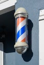 Striped barber pole in glass mounted on a wall