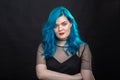 Sryle and fashion concept - Close up portrait of woman with blue long hair over black background Royalty Free Stock Photo