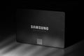 SSD Samsung 860 EVO 250MB on the grey background closeup with deep shadows, black and white photo