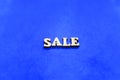 Sseamless pattern of colored butterflies with felt on a white backgroundsale wooden letters on blue background