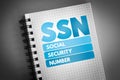 SSN - Social Security Number acronym on notepad, concept background