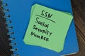 SSN - Social Security Number write on sticky notes isolated on Wooden Table Royalty Free Stock Photo