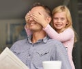 Ssshhh...dont blow my cover. a young girl surprising her dad by covering her hands over his eyes. Royalty Free Stock Photo