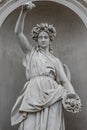 Statue of sensual busty and puffy renaissance era woman in circlet of flowers, Potsdam, Germany, details, closeup Royalty Free Stock Photo