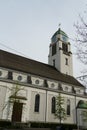 St. Agatha Roman Catholic Church in Dietikon, Switzerland, lateral view. Information poster concerning coronavirus