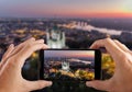 Travel concept. Hands making photo of St. Andrew`s Church Kiev Ukraine. Cityscape from a height. Royalty Free Stock Photo