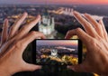 Travel concept. Hands making photo of St. Andrew`s Church Kiev Ukraine. Cityscape from a height. Royalty Free Stock Photo