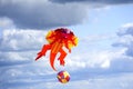 Large orange Dragon kite flying high Royalty Free Stock Photo