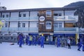 People in ski wear standing against the background of hotel at ski resort