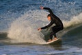 St. Augustine, FL - FEb 17 - Surfer rides the waves at sunset in St