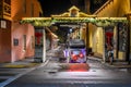 Woman taking picture of carriage on illuminated street at Old Town in Florida`s Historic Coast .