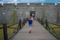 Girl walking in main entrance of Castillo de San Marcos Fort in Florida`s Historic Coast. Royalty Free Stock Photo