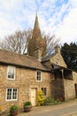 St Augustine`s church behind a quaint cottage on Front Street Alston, Cumbria, UK