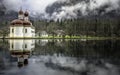 St. Bartholomew`s Church is mirrored on the surface of the Koenigssee Lake
