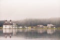 St. Bartholomews church in the morning fog, Konigsee lake, Bavaria, Germany. Alpine lake with church on the bank. Royalty Free Stock Photo