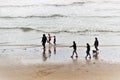 People walk along the beach. On the west coast of England.