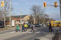 St.Catharines. Ontario. Canada-01.29.2020 pedestrian crossing with traffic light. Eighty year old crossing guard. Children cross t