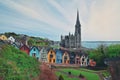 St. Colman`s Cathedral And Colored Houses In Cobh, Ireland