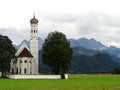 St Coloman church building in green fields at alpine landscape