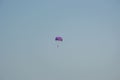 Ocean view of a man parasailing in the sea, towed by speedboat, nature activity outdoors, summer, parasail above water