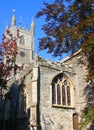 St Fimbarrus Church, parish church at Fowey, Cornwall framed by trees in leaf and a cloudless blue sky.. Royalty Free Stock Photo