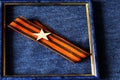 St. George ribbon with the star frame on blue background