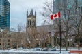 St. George`s Anglican Church at Canada Square with flag - Montreal, Quebec, Canada