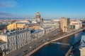 St. Isaac`s Cathedral in the distance above the rooftops of the city of Saint-Petersburg, view heights of the Moika River and the