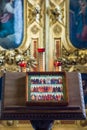 Church candles are burning on a large golden vintage candlestick in the orthodox church. Christian faith and traditions. Theme of Royalty Free Stock Photo