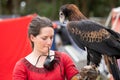 Captive wedge tailed eagle with female trainer / handler getting ready for flight exhibition at a show