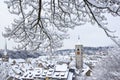 The St. Johan church tower over the old town roofs after a winter snow fall in Schaffhausen Royalty Free Stock Photo