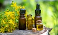 St. John's wort flower oil in a glass bottle. on a wooden background. Royalty Free Stock Photo