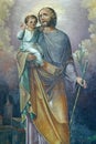 St. Joseph holds the baby Jesus