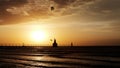 Kite boarder in the air at sunset by a lighthouse Royalty Free Stock Photo