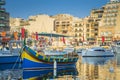 St.Julian`s, Malta - Colorful Luzzu fishing boats at Spinola bay Royalty Free Stock Photo