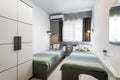 St Julians, Malta - April 28th 2020: Small twin bedroom with turqoise green bedding